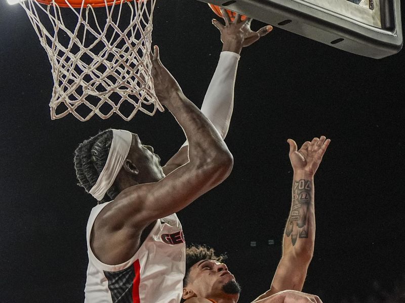 Jan 28, 2026; Athens, Georgia, USA; Tennessee Volunteers guard Bishop Boswell (3) shoots over Georgia Bulldogs center Somto Cyril (2) during the second half at Stegeman Coliseum. Mandatory Credit: Dale Zanine-Imagn Images