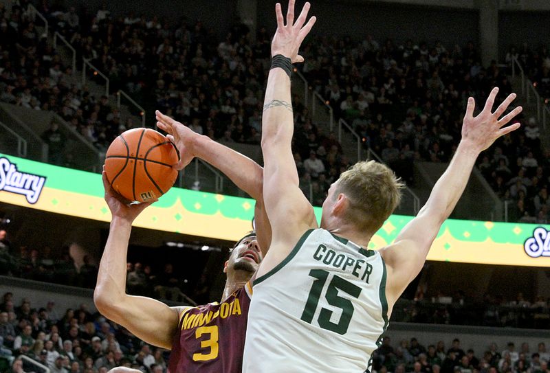 Jan 28, 2025; East Lansing, Michigan, USA;  Minnesota Golden Gophers forward Dawson Garcia (3) can’t get this shot past Michigan State Spartans center Carson Cooper (15) during the first half at Jack Breslin Student Events Center. Mandatory Credit: Dale Young-Imagn Images