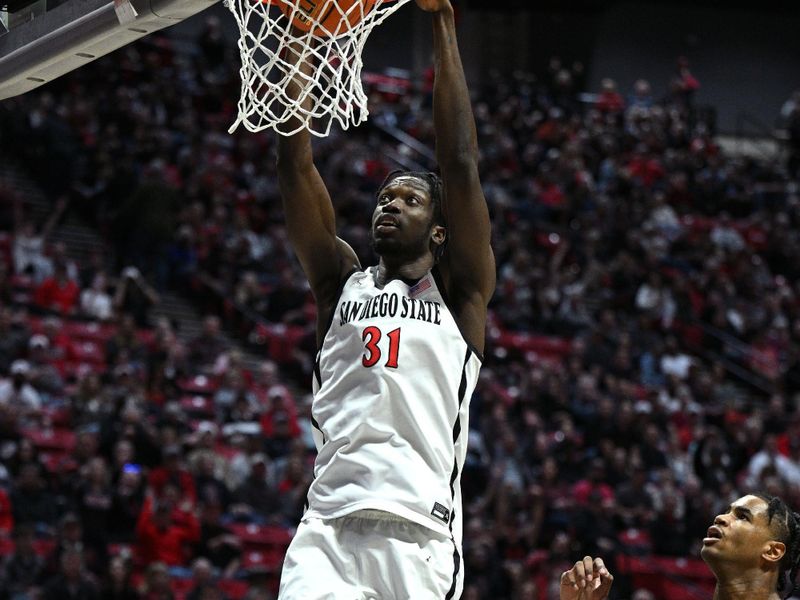 Feb 11, 2023; San Diego, California, USA; San Diego State Aztecs forward Nathan Mensah (31) dunks the ball during the first half against the UNLV Rebels at Viejas Arena. Mandatory Credit: Orlando Ramirez-USA TODAY Sports