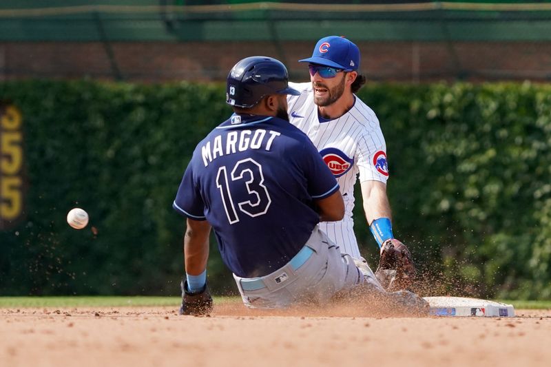 May 31, 2023; Chicago, Illinois, USA; Tampa Bay Rays center fielder Manuel Margot (13) steals second base as Chicago Cubs shortstop Dansby Swanson (7) takes the throw during the ninth inning at Wrigley Field. Mandatory Credit: David Banks-USA TODAY Sports
