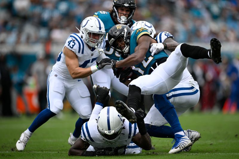 Jacksonville Jaguars tight end Brenton Strange (85) is tackled by Indianapolis Colts' Drew Ogletree (85) during the first half of an NFL football game, Sunday, Oct. 6, 2024, in Jacksonville, Fla. (AP Photo/Phelan M. Ebenhack)