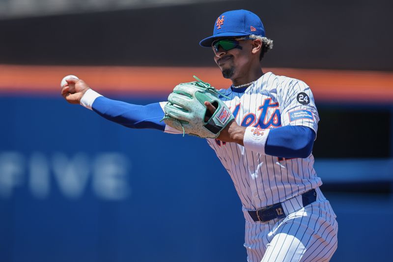 Jul 11, 2024; New York City, New York, USA; New York Mets shortstop Francisco Lindor (12) throws the ball to first base for an out during the first inning against the Washington Nationals at Citi Field. Mandatory Credit: Vincent Carchietta-USA TODAY Sports