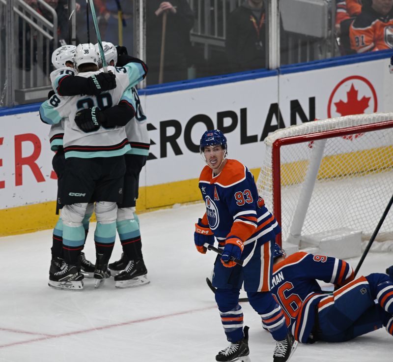 Mar 22, 2025; Edmonton, Alberta, CAN;  Seattle Kraken right wing Jani Nyman (38) with Kraken right wing Kaapo Kakko (84) celebrate a gaol on Edmonton Oilers goalie Stuart Skinner (74) as Oilers centre Ryan Nugent-Hopkins (93) skates by during the first period at Rogers Place. Mandatory Credit: Walter Tychnowicz-Imagn Images