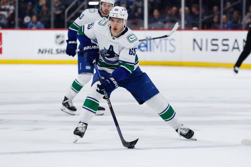 Apr 18, 2024; Winnipeg, Manitoba, CAN;  Vancouver Canucks forward Ilya Mikheyev (65) skates into the Winnipeg Jets zone during the first period at Canada Life Centre. Mandatory Credit: Terrence Lee-USA TODAY Sports