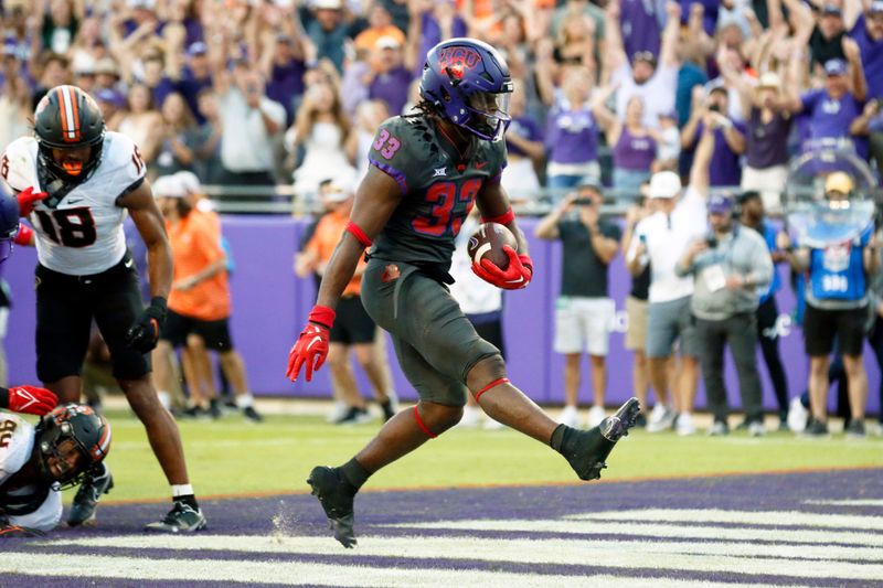 Oct 15, 2022; Fort Worth, Texas, USA; TCU Horned Frogs running back Kendre Miller (33) scores the game winning touchdown in the second overtime against the Oklahoma State Cowboys at Amon G. Carter Stadium. Mandatory Credit: Raymond Carlin III-USA TODAY Sports