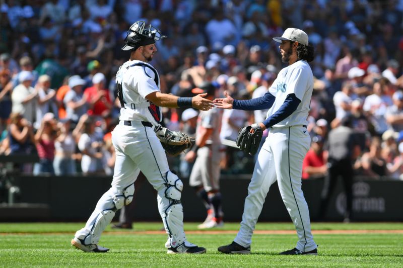 Jul 4, 2024; Seattle, Washington, USA; Seattle Mariners catcher Cal Raleigh (29) and relief pitcher Andres Munoz (75) celebrate defeating the Baltimore Orioles at T-Mobile Park. Mandatory Credit: Steven Bisig-USA TODAY Sports