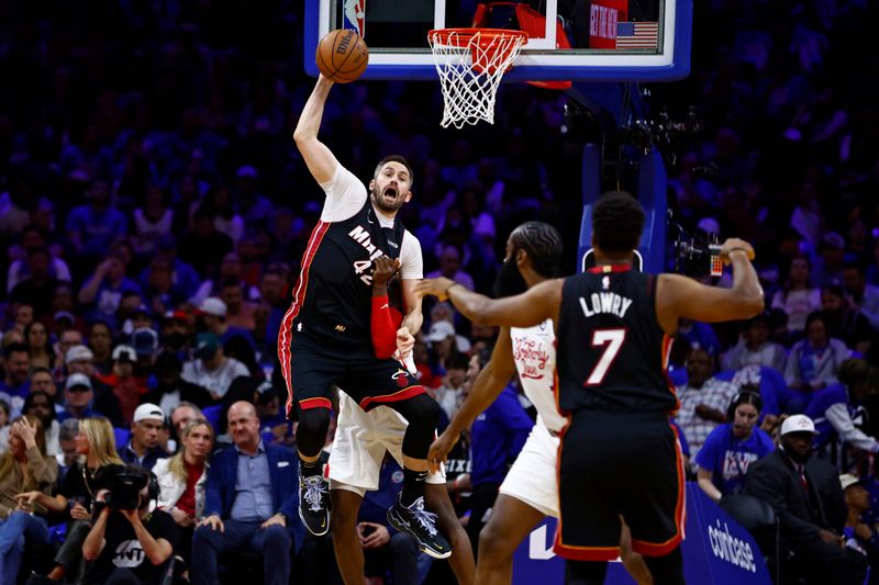 PHILADELPHIA, PA - APRIL 06: Kevin Love #42 of the Miami Heat jumps to catch a pass in between Jalen McDaniels #7 and James Harden #1 of the Philadelphia 76ers during the first half of a game at Wells Fargo Center on April 6, 2023 in Philadelphia, Pennsylvania. The Heat defeated the 76ers 129-101. NOTE TO USER: User expressly acknowledges and agrees that, by downloading and or using this photograph, User is consenting to the terms and conditions of the Getty Images License Agreement. (Photo by Rich Schultz/Getty Images)