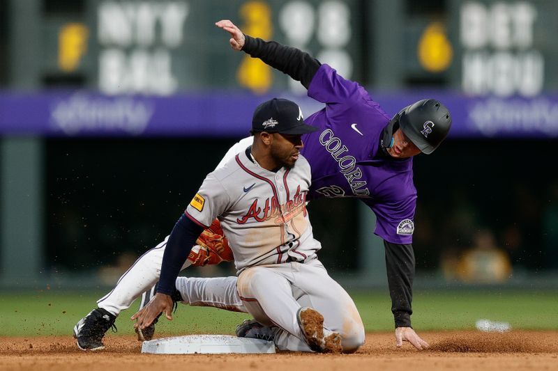 Apr 28, 2025; Denver, Colorado, USA; Colorado Rockies right fielder Mickey Moniak (22) is tagged out attempting to steal second against Atlanta Braves second baseman Ozzie Albies (1) in the fourth inning at Coors Field. Mandatory Credit: Isaiah J. Downing-Imagn Images