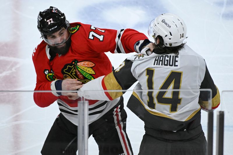 Jan 18, 2025; Chicago, Illinois,  USA;  Vegas Golden Knights defenseman Nicolas Hague (14) and Chicago Blackhawks left wing Patrick Maroon (77) fight  during the second period at United Center. Mandatory Credit: Matt Marton-Imagn Images