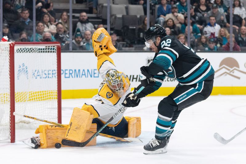 Feb 24, 2024; San Jose, California, USA; Nashville Predators goaltender Juuse Saros (74) blocks the puck from San Jose Sharks center Ryan Carpenter (22) during the second period at SAP Center at San Jose. Mandatory Credit: Stan Szeto-USA TODAY Sports