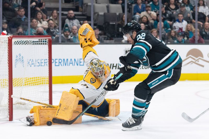 Feb 24, 2024; San Jose, California, USA; Nashville Predators goaltender Juuse Saros (74) blocks the puck from San Jose Sharks center Ryan Carpenter (22) during the second period at SAP Center at San Jose. Mandatory Credit: Stan Szeto-USA TODAY Sports