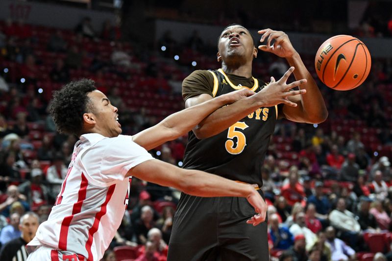 Feb 3, 2024; Las Vegas, Nevada, USA; Wyoming Cowboys forward Cam Manyawu (5) is fouled by UNLV Rebels guard Dedan Thomas Jr. (11) in the second half at Thomas & Mack Center. Mandatory Credit: Candice Ward-USA TODAY Sports