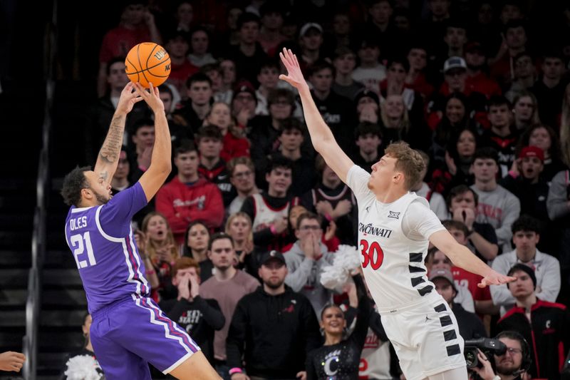 Jan 16, 2024; Cincinnati, Ohio, USA;  TCU Horned Frogs forward JaKobe Coles (21) shoots against Cincinnati Bearcats forward Viktor Lakhin (30) in the first half at Fifth Third Arena. Mandatory Credit: Aaron Doster-USA TODAY Sports