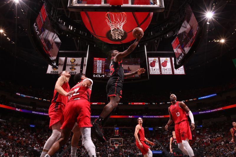 MIAMI, FL - DECEMBER 12:  Davion Mitchell #45 of the Toronto Raptors shoots the ball during the game against the Miami Heat on December 12, 2024 at Kaseya Center in Miami, Florida. NOTE TO USER: User expressly acknowledges and agrees that, by downloading and or using this Photograph, user is consenting to the terms and conditions of the Getty Images License Agreement. Mandatory Copyright Notice: Copyright 2024 NBAE (Photo by Issac Baldizon/NBAE via Getty Images)