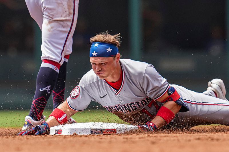 May 15, 2025; Cumberland, Georgia, USA; Washington Nationals outfielder Alex Call (17) slides into second base against the Atlanta Braves during the second inning at Truist Park. Mandatory Credit: Dale Zanine-Imagn Images