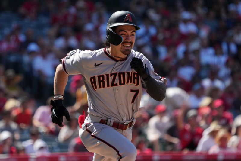 Jul 2, 2023; Anaheim, California, USA; Arizona Diamondbacks left fielder Corbin Carroll (7) runs to first base on a single in the ninth inning against the Los Angeles Angels at Angel Stadium. Mandatory Credit: Kirby Lee-USA TODAY Sports