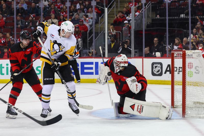 Mar 19, 2024; Newark, New Jersey, USA; New Jersey Devils goaltender Jake Allen (34) makes a save against the Pittsburgh Penguins during the third period at Prudential Center. Mandatory Credit: Ed Mulholland-USA TODAY Sports