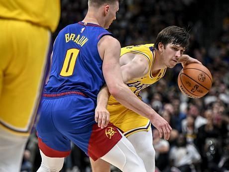 DENVER, CO - OCTOBER 24: Christian Braun (0) of the Denver Nuggets defends Austin Reaves (15) of the Los Angeles Lakers during the fourth quarter of the Nuggets' 119-107 win at Ball Arena in Denver on Tuesday, October 24, 2023. (Photo by AAron Ontiveroz/The Denver Post)