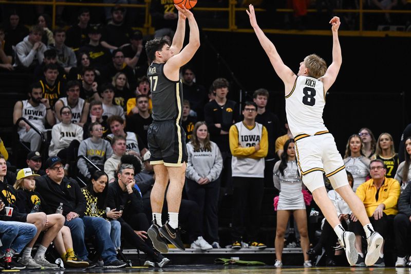 Feb 14, 2026; Iowa City, Iowa, USA; Purdue Boilermakers guard Omer Mayer (17) shoots the ball as Iowa Hawkeyes forward Cooper Koch (8) defends during the second half at Carver-Hawkeye Arena. Mandatory Credit: Jeffrey Becker-Imagn Images