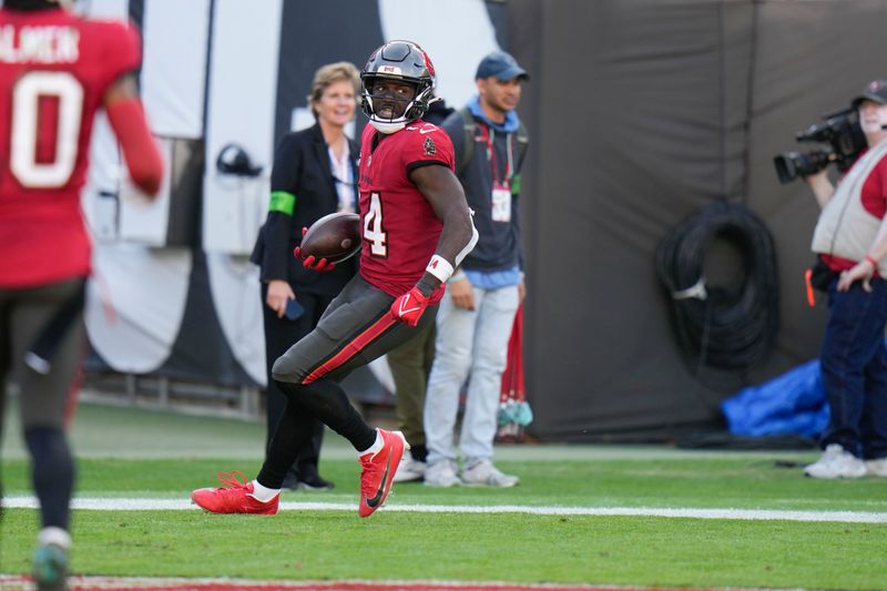 Tampa Bay Buccaneers wide receiver Chris Godwin (14) scores on a touchdown reception in the second half of an NFL football game against the New Orleans Saints in Tampa, Fla., Sunday, Dec. 31, 2023. (AP Photo/Chris O'Meara)