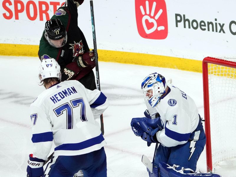 Feb 15, 2023; Tempe, Arizona, USA; Tampa Bay Lightning goaltender Brian Elliott (1) makes a save in front of Arizona Coyotes center Nick Bjugstad (17) and Tampa Bay Lightning defenseman Victor Hedman (77) during the third period at Mullett Arena. Mandatory Credit: Joe Camporeale-USA TODAY Sports