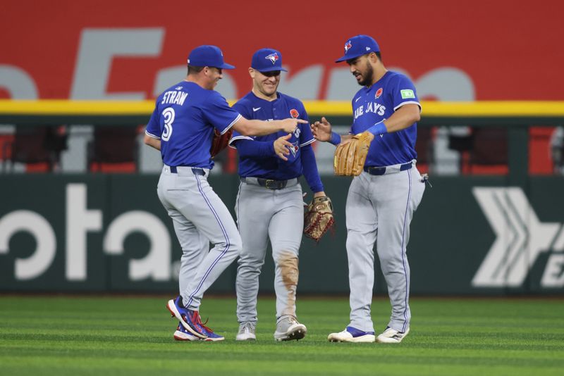 May 26, 2025; Arlington, Texas, USA; Toronto Blue Jays outfielder Myles Straw (3), outfielder Daulton Varsho (5) and outfielder Myles Straw (3) cerebrate after winning the game against the Texas Rangers at Globe Life Field. Mandatory Credit: Tim Heitman-Imagn Images