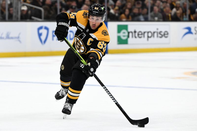 Nov 9, 2024; Boston, Massachusetts, USA; Boston Bruins left wing Brad Marchand (63) passes the puck against the Ottawa Senators during the first period at TD Garden. Mandatory Credit: Brian Fluharty-Imagn Images