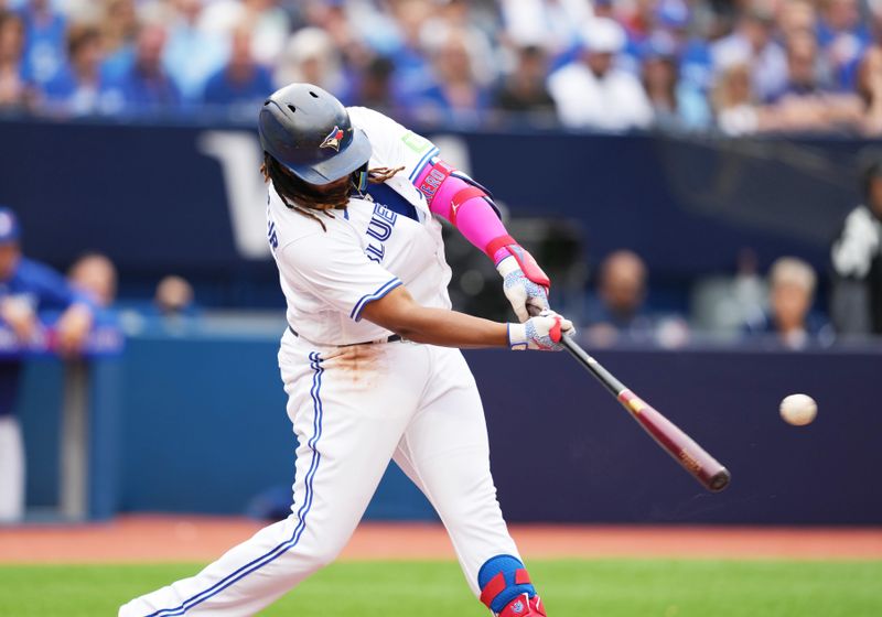 Sep 9, 2023; Toronto, Ontario, CAN; Toronto Blue Jays first baseman Vladimir Guerrero Jr. (27) hits a single against the Kansas City Royals during the fourth inning at Rogers Centre. Mandatory Credit: Nick Turchiaro-USA TODAY Sports