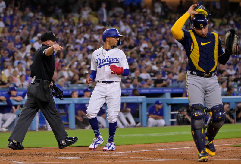 Aug 16, 2023; Los Angeles, California, USA;  Home plate umpire Dan Merzel (107) calls Los Angeles Dodgers right fielder Mookie Betts (50) safe at home on an interference call on Milwaukee Brewers catcher William Contreras (24) in the second inning at Dodger Stadium. Mandatory Credit: Jayne Kamin-Oncea-USA TODAY Sports