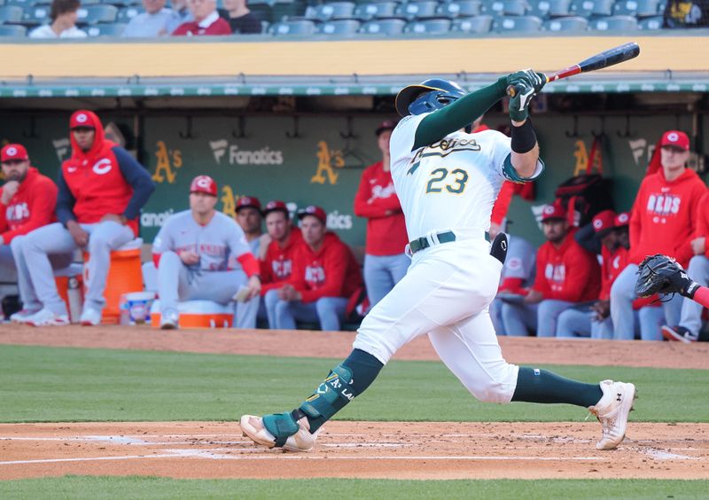 Apr 28, 2023; Oakland, California, USA; Oakland Athletics catcher Shea Langeliers (23) hits an RBI single against the Cincinnati Reds during the first inning at Oakland Coliseum. Mandatory Credit: Kelley L Cox-USA TODAY Sports