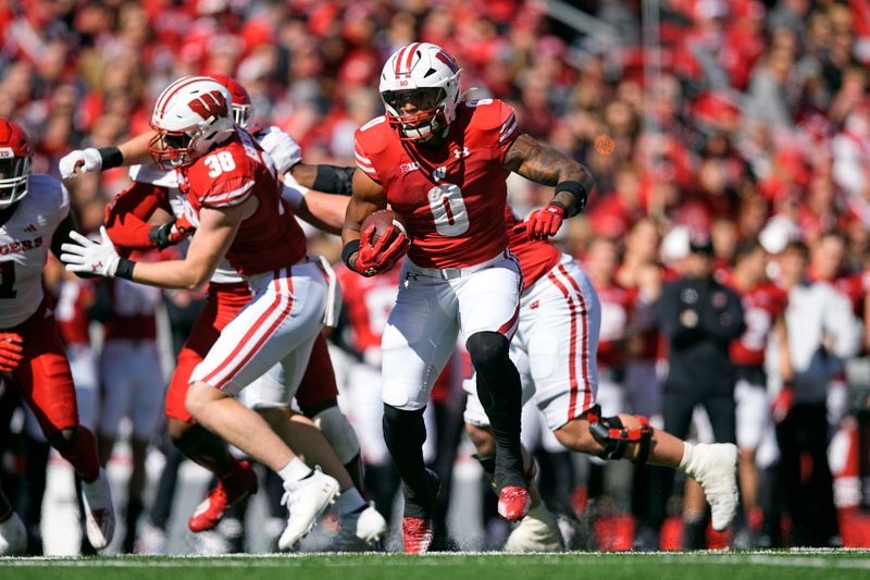 Oct 7, 2023; Madison, Wisconsin, USA;  Wisconsin Badgers running back Braelon Allen (0) rushes with the football during the second quarter against the Rutgers Scarlet Knights at Camp Randall Stadium. Mandatory Credit: Jeff Hanisch-USA TODAY Sports