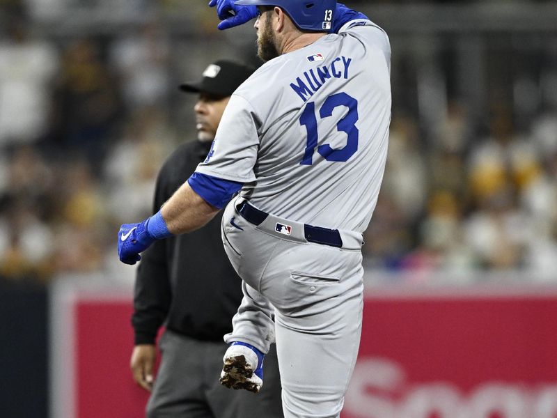 Oct 9, 2024; San Diego, California, USA; Los Angeles Dodgers third baseman Max Muncy (13) reacts after hitting a double in the third inning against the San Diego Padres during game four of the NLDS for the 2024 MLB Playoffs at Petco Park.  Mandatory Credit: Denis Poroy-Imagn Images