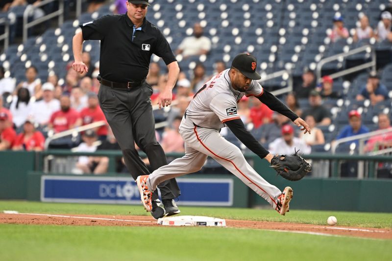 Aug 6, 2024; Washington, District of Columbia, USA; San Francisco Giants first baseman LaMonte Wade Jr. (31) plays a ground ball at first base against the Washington Nationals during the first inning at Nationals Park. Mandatory Credit: Rafael Suanes-USA TODAY Sports