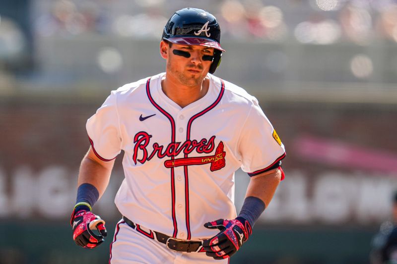 Apr 7, 2024; Cumberland, Georgia, USA; Atlanta Braves third baseman Austin Riley (27) runs after hitting a home run against the Arizona Diamondbacks during the eighth inning at Truist Park. Mandatory Credit: Dale Zanine-USA TODAY Sports