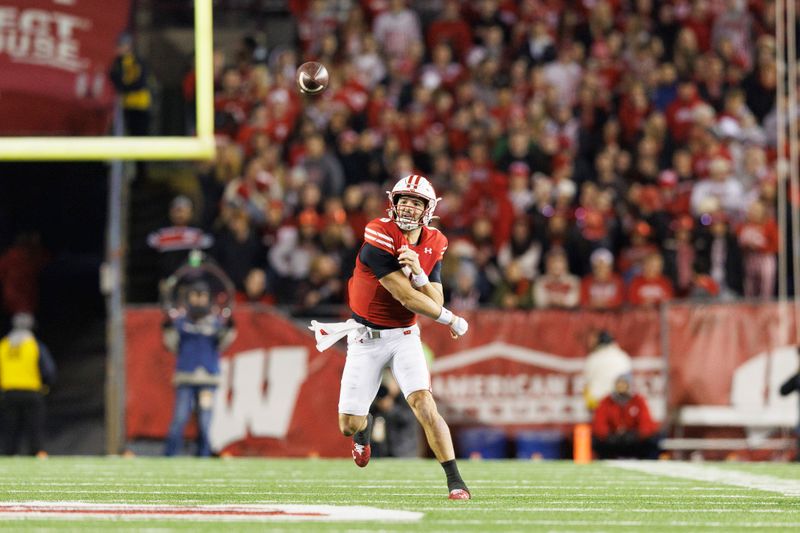 Nov 18, 2023; Madison, Wisconsin, USA;  Wisconsin Badgers quarterback Tanner Mordecai (8) throws a pass during the third quarter against the Nebraska Cornhuskers at Camp Randall Stadium. Mandatory Credit: Jeff Hanisch-USA TODAY Sports