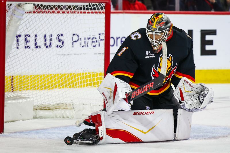 Mar 5, 2026; Calgary, Alberta, CAN; Calgary Flames goaltender Devin Cooley (1) makes a save against the Ottawa Senators during the third period at Scotiabank Saddledome. Mandatory Credit: Sergei Belski-Imagn Images