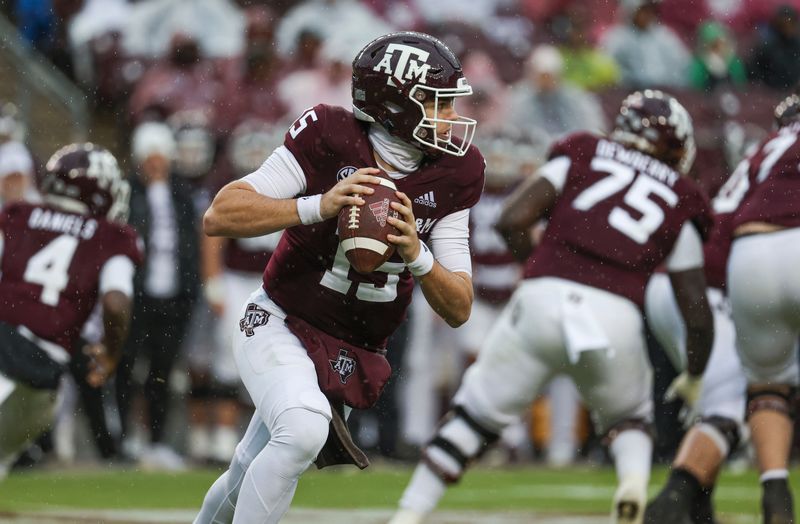 Nov 19, 2022; College Station, Texas, USA; Texas A&M Aggies quarterback Conner Weigman (15) rolls out of the pocket with the ball on a play during the second quarter against the Massachusetts Minutemen at Kyle Field. Mandatory Credit: Troy Taormina-USA TODAY Sports