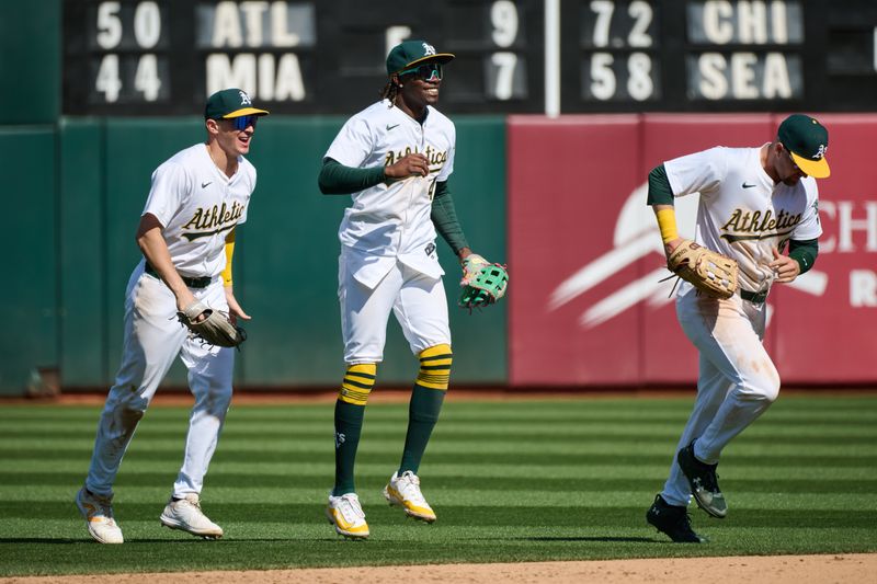 Apr 14, 2024; Oakland, California, USA; Oakland Athletics outfielders outfielder JJ Bleday (33), Seth Brown (15) and outfielder Lawrence Butler (4) celebrate after the last out of the ninth inning against the Washington Nationals at Oakland-Alameda County Coliseum Mandatory Credit: Robert Edwards-USA TODAY Sports