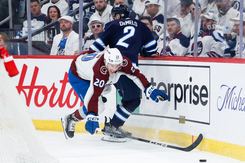 Apr 23, 2024; Winnipeg, Manitoba, CAN; Colorado Avalanche forward Ross Colton (20) reaches for the puck past Winnipeg Jets defenseman Dylan DeMelo (2) during the first period in game two of the first round of the 2024 Stanley Cup Playoffs at Canada Life Centre. Mandatory Credit: Terrence Lee-USA TODAY Sports