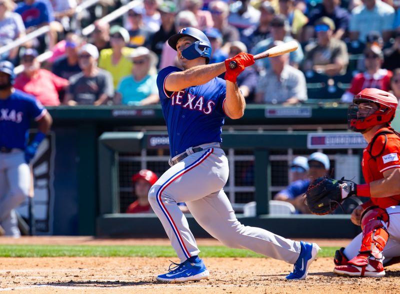 Mar 20, 2024; Goodyear, Arizona, USA; Texas Rangers outfielder Wyatt Langford hits a home run against the Cincinnati Reds during a spring training baseball game at Goodyear Ballpark. Mandatory Credit: Mark J. Rebilas-USA TODAY Sports
