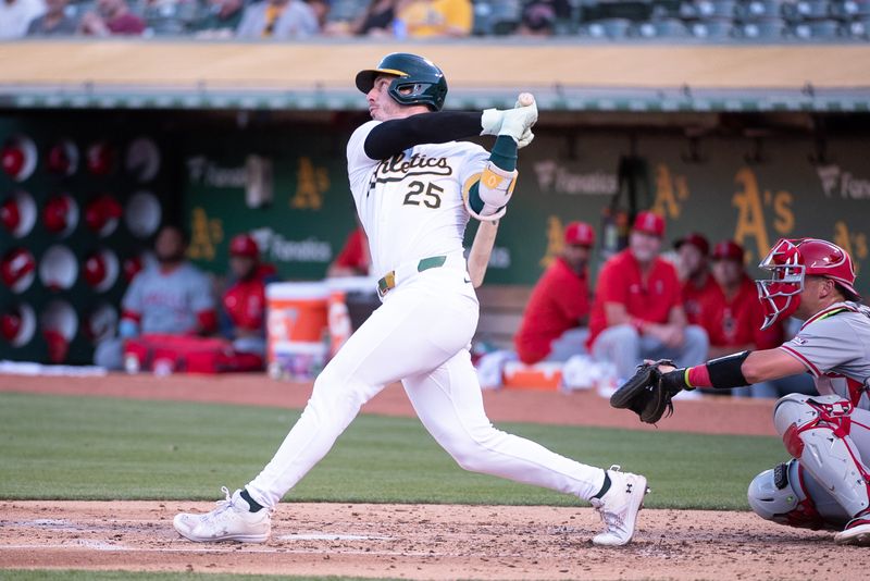 Jul 2, 2024; Oakland, California, USA; Oakland Athletics outfielder Brent Rooker (25) hits a home run against the Los Angeles Angels during the fourth inning at Oakland-Alameda County Coliseum. Mandatory Credit: Ed Szczepanski-USA TODAY Sports