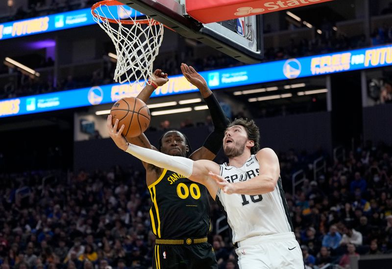 SAN FRANCISCO, CALIFORNIA - NOVEMBER 24: Cedi Osman #16 of the San Antonio Spurs drives to the basket against Jonathan Kuminga #00 of the Golden State Warriors during the first quarter of the NBA In-Season Tournament game at Chase Center on November 24, 2023 in San Francisco, California. NOTE TO USER: User expressly acknowledges and agrees that, by downloading and or using this photograph, User is consenting to the terms and conditions of the Getty Images License Agreement. (Photo by Thearon W. Henderson/Getty Images)