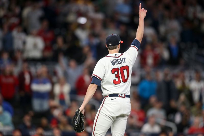 Oct 12, 2022; Atlanta, Georgia, USA; Atlanta Braves starting pitcher Kyle Wright (30) points skyward to teammates for a fly ball against the Philadelphia Phillies in the fifth inning during game two of the NLDS for the 2022 MLB Playoffs at Truist Park. Mandatory Credit: Brett Davis-USA TODAY Sports