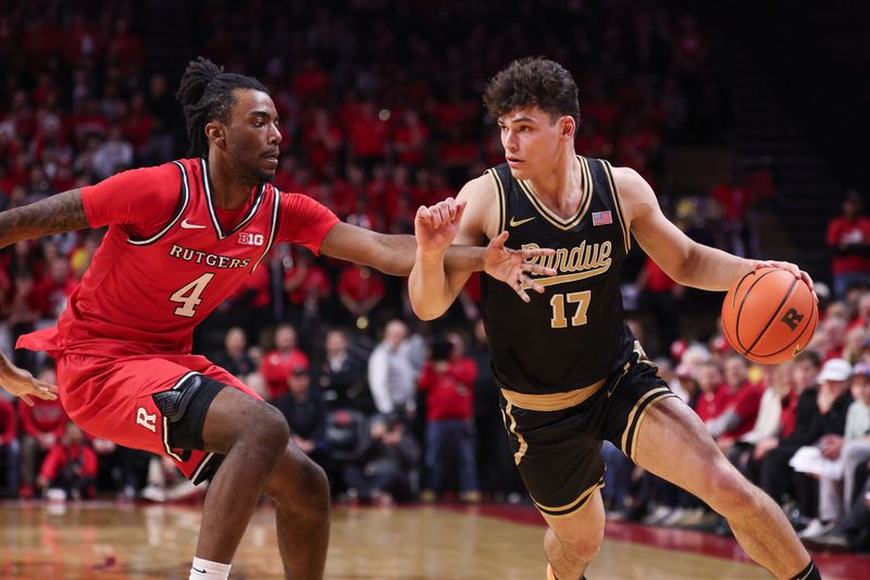 Dec 2, 2025; Piscataway, New Jersey, USA; Purdue Boilermakers guard Omer Mayer (17) dribbles against Rutgers Scarlet Knights forward Bryce Dortch (4) during the first half at Jersey Mike's Arena. Mandatory Credit: Vincent Carchietta-Imagn Images