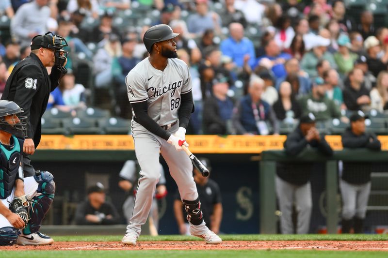 Jun 13, 2024; Seattle, Washington, USA; Chicago White Sox center fielder Luis Robert Jr. (88) hits a home run against the Seattle Mariners during the third inning at T-Mobile Park. Mandatory Credit: Steven Bisig-USA TODAY Sports