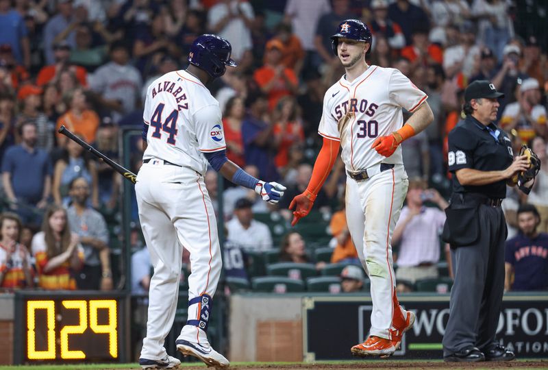 May 21, 2024; Houston, Texas, USA; Houston Astros right fielder Kyle Tucker (30) celebrates with designated hitter Yordan Alvarez (44) after hitting a home run during the seventh inning against the Los Angeles Angels at Minute Maid Park. Mandatory Credit: Troy Taormina-USA TODAY Sports