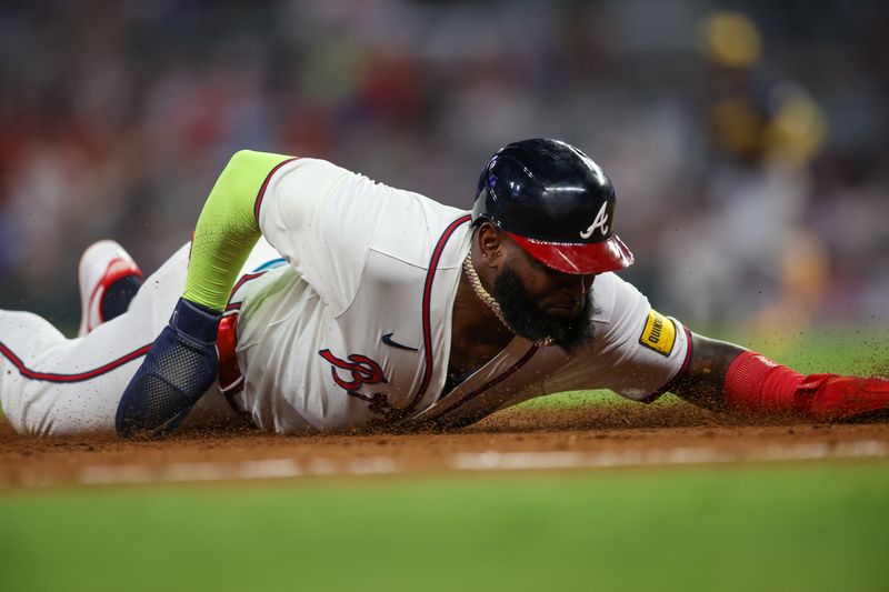 Aug 7, 2024; Atlanta, Georgia, USA; Atlanta Braves designated hitter Marcell Ozuna (20) slides safely into third against the Milwaukee Brewers in the fifth inning at Truist Park. Mandatory Credit: Brett Davis-USA TODAY Sports
