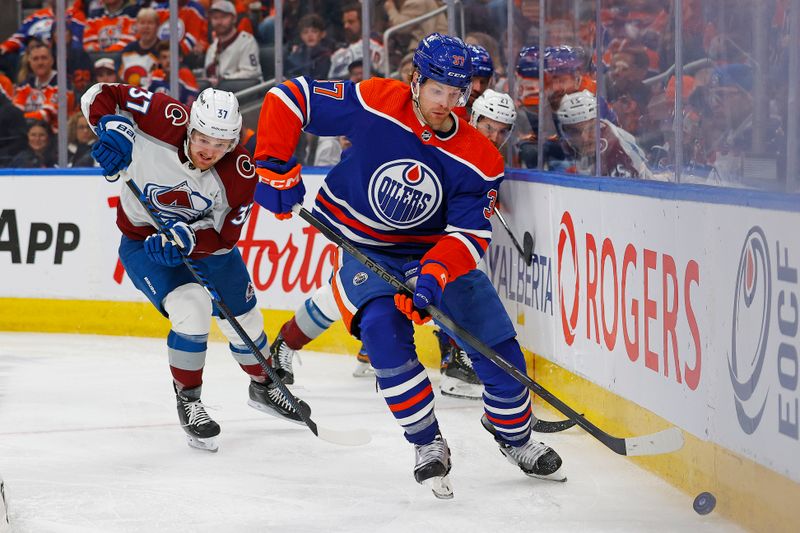 iMar 16, 2024; Edmonton, Alberta, CAN; Edmonton Oilers forward Warren Foegele (37) clears the puck in front of Colorado Avalanche Casey Mittelstadt (37) during the second period at Rogers Place. Mandatory Credit: Perry Nelson-USA TODAY Sports