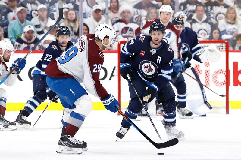 Apr 30, 2024; Winnipeg, Manitoba, CAN; Winnipeg Jets defenseman Josh Morrissey (44) gets set to block a shot by Colorado Avalanche center Nathan MacKinnon (29) in the second period in game five of the first round of the 2024 Stanley Cup Playoffs at Canada Life Centre. Mandatory Credit: James Carey Lauder-USA TODAY Sports