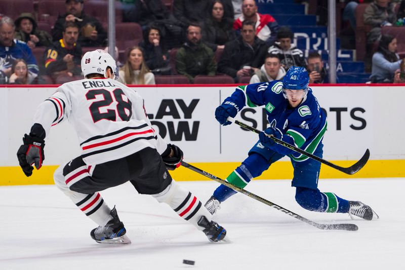 Apr 6, 2023; Vancouver, British Columbia, CAN; Vancouver Canucks forward Elias Pettersson (40) makes a pass around Chicago Blackhawks defenseman Andreas Englund (28) in the second period at Rogers Arena. Mandatory Credit: Bob Frid-USA TODAY Sports